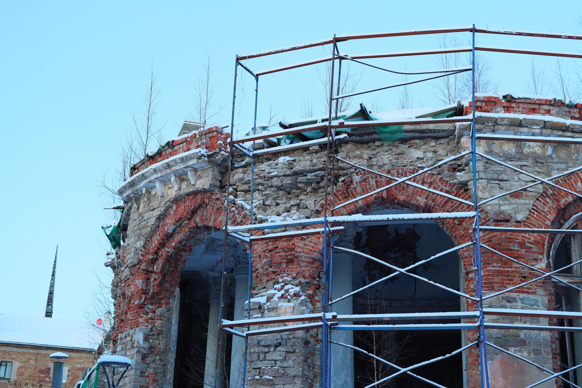 The restoration work of a historic brick building is currently underway and is under construction